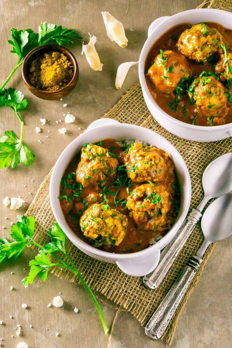 An aerial shot of two bowls of curried feta-lamb meatballs.
