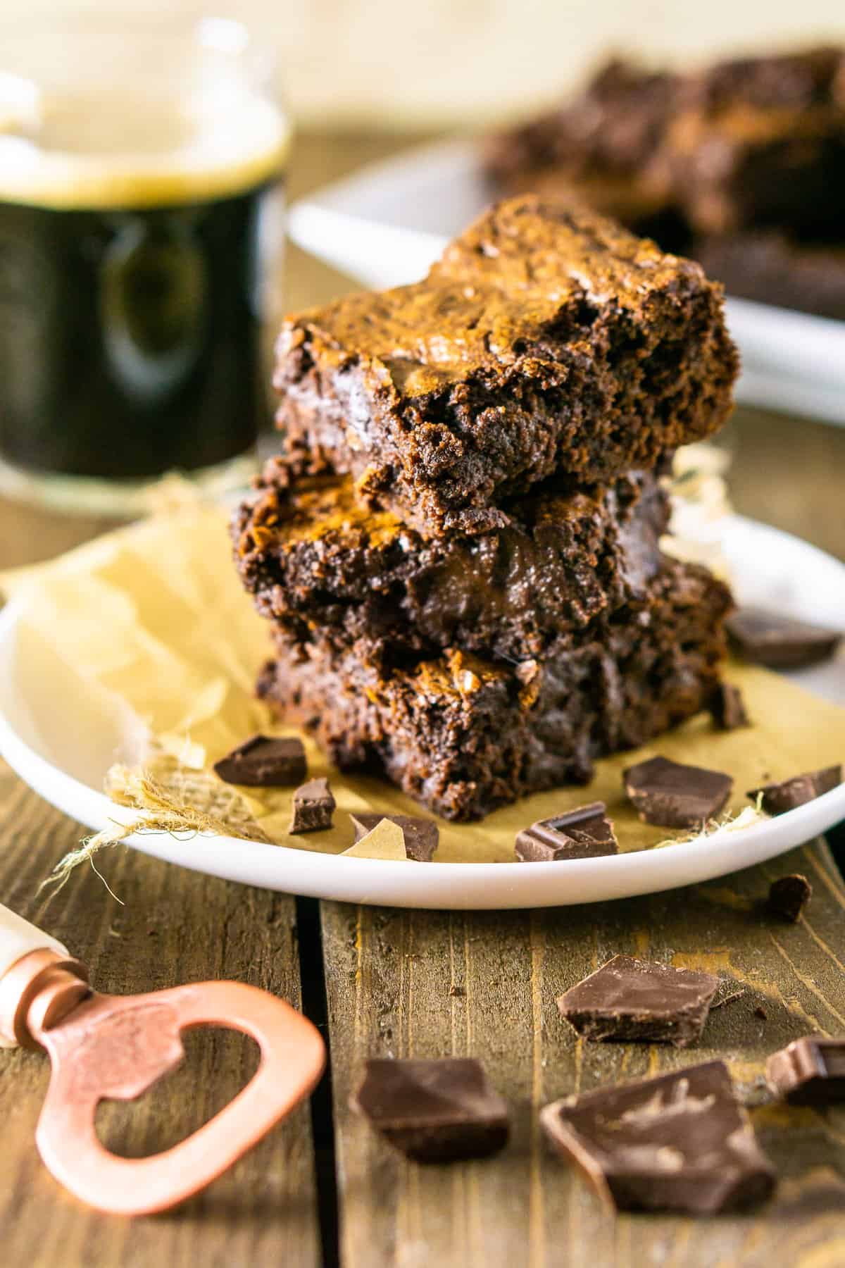 The stack of fudgy stout brownies with a stout beer.