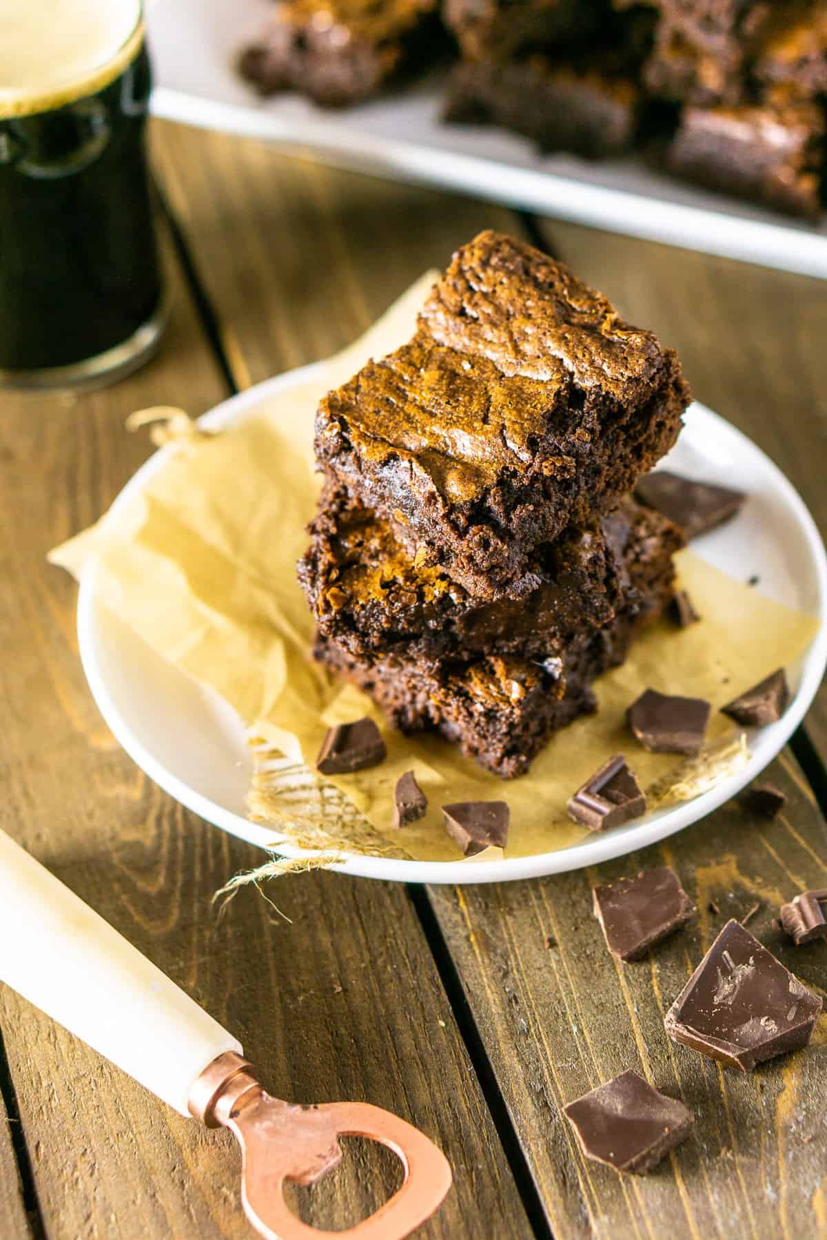 A stack of fudgy stout brownies with a stout and bottle opener.