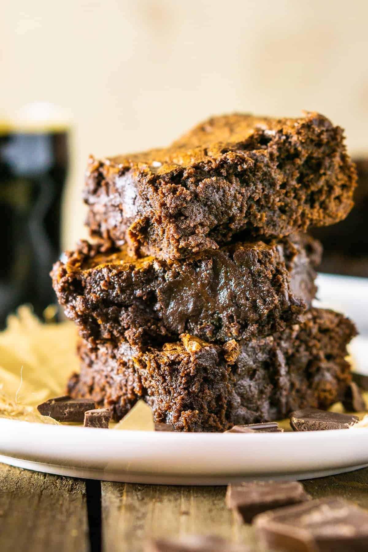 A close-up front view of a stack of fudgy stout brownies.