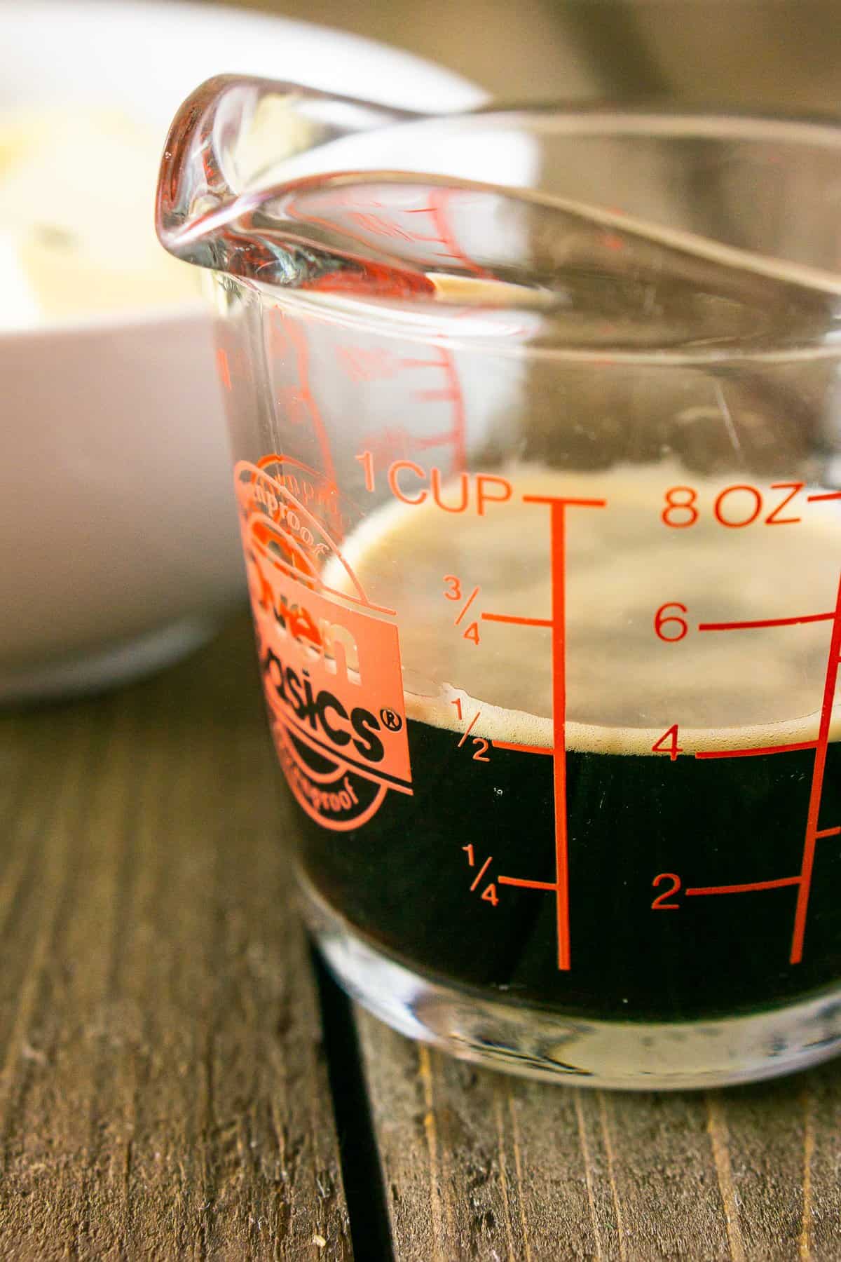 A measuring cup of beer ready to use for the brownie batter.