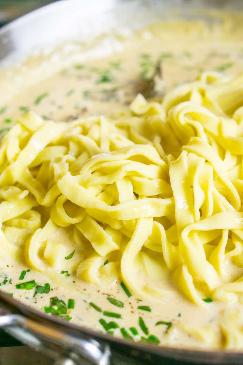 Fettuccine in the Parmesan cream sauce ready to be mixed.