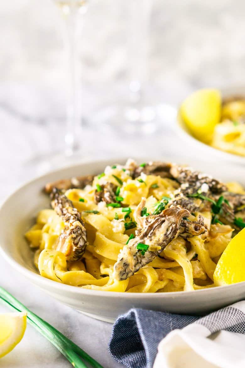 The morel mushroom pasta with wine glasses.