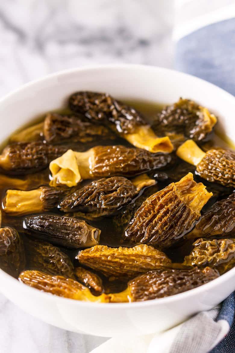 A bowl of morel mushrooms rehydrating.