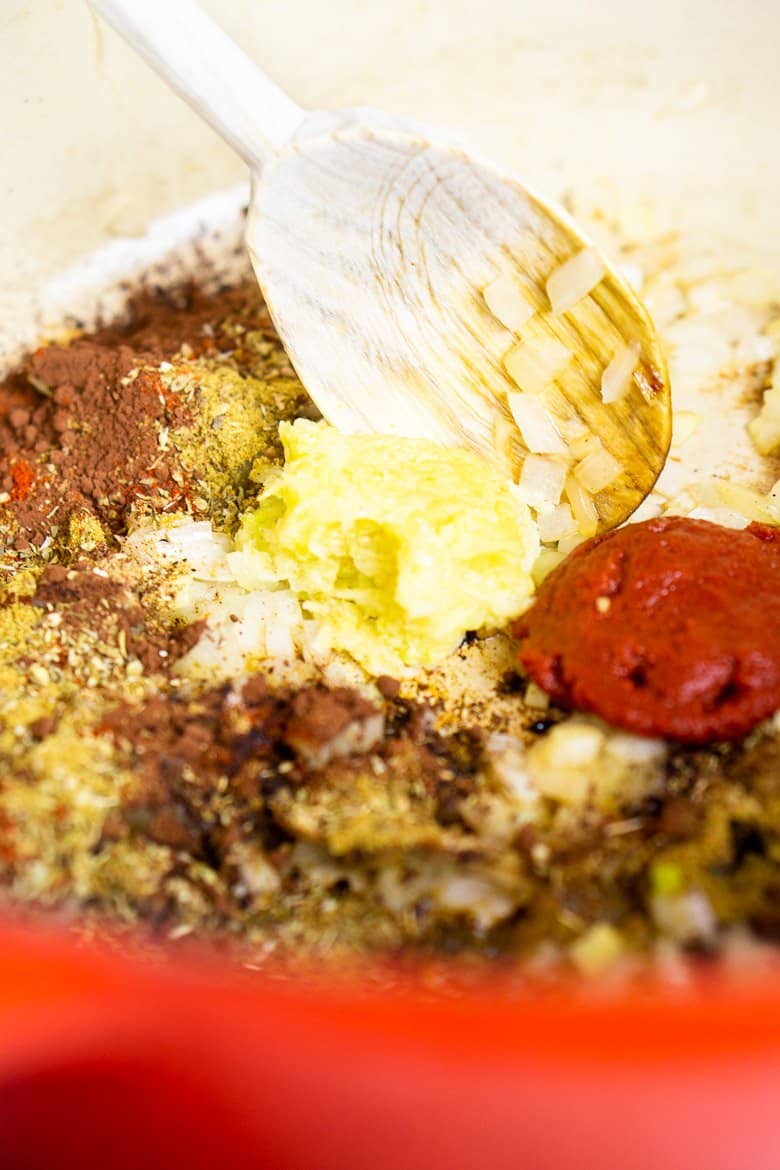 Toasting the garlic, spices and tomato paste in the Dutch oven.