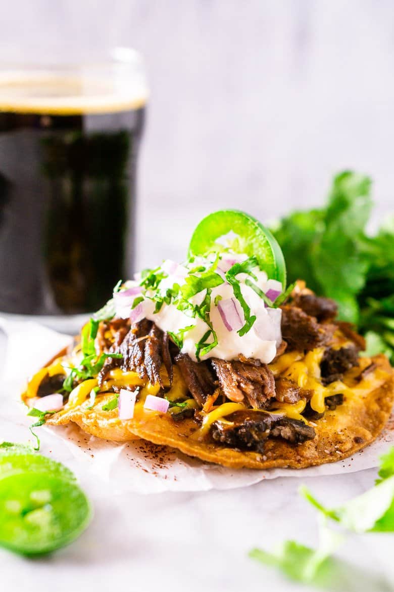 The beer-braised Mexican shredded beef on a tostada with a stout in the background.