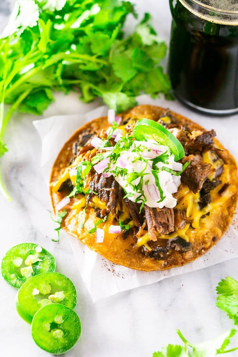 An aerial view of the beer-braised Mexican shredded beef on a tostada.