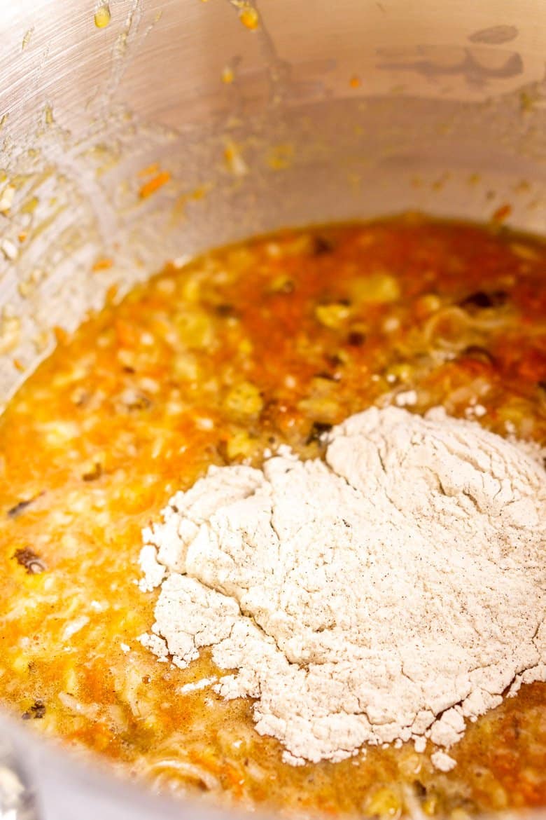 Adding the dry ingredients to the homemade carrot cake batter.