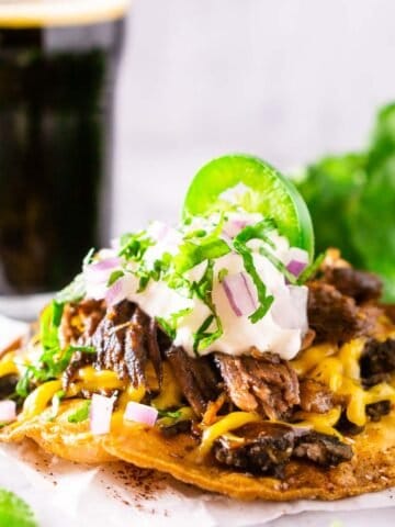 The beer-braised Mexican shredded beef on a tostada with a stout in the background.