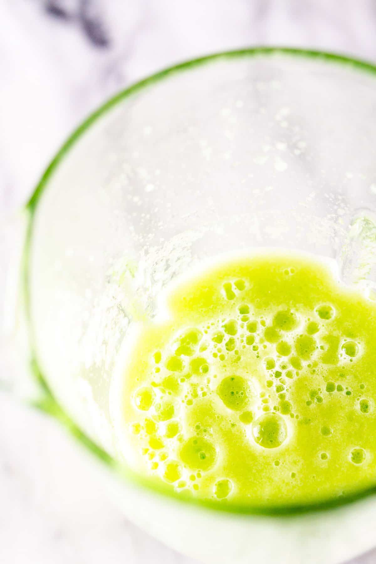 A blender full of cucumber puree to make cucumber juice.