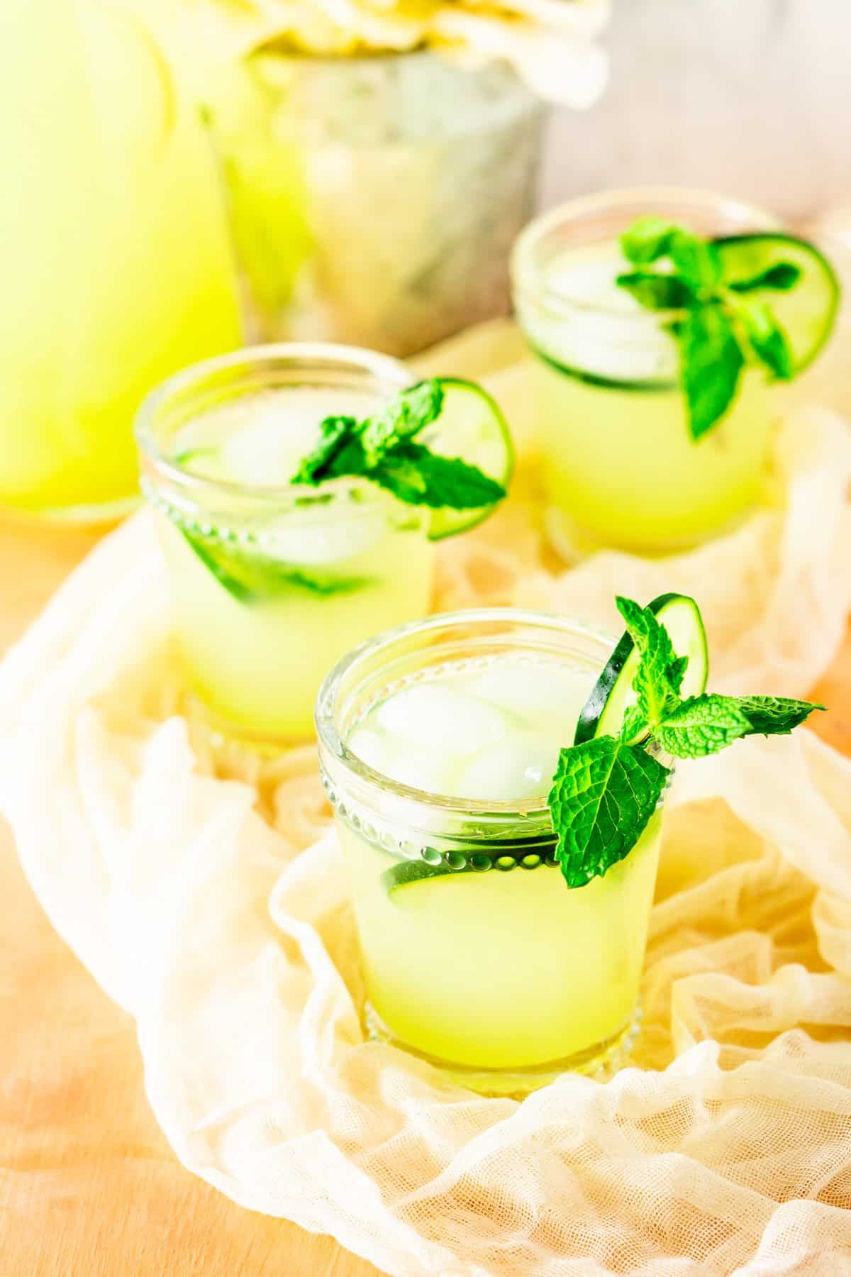Looking down into three glasses of mint-cucumber lemonade.