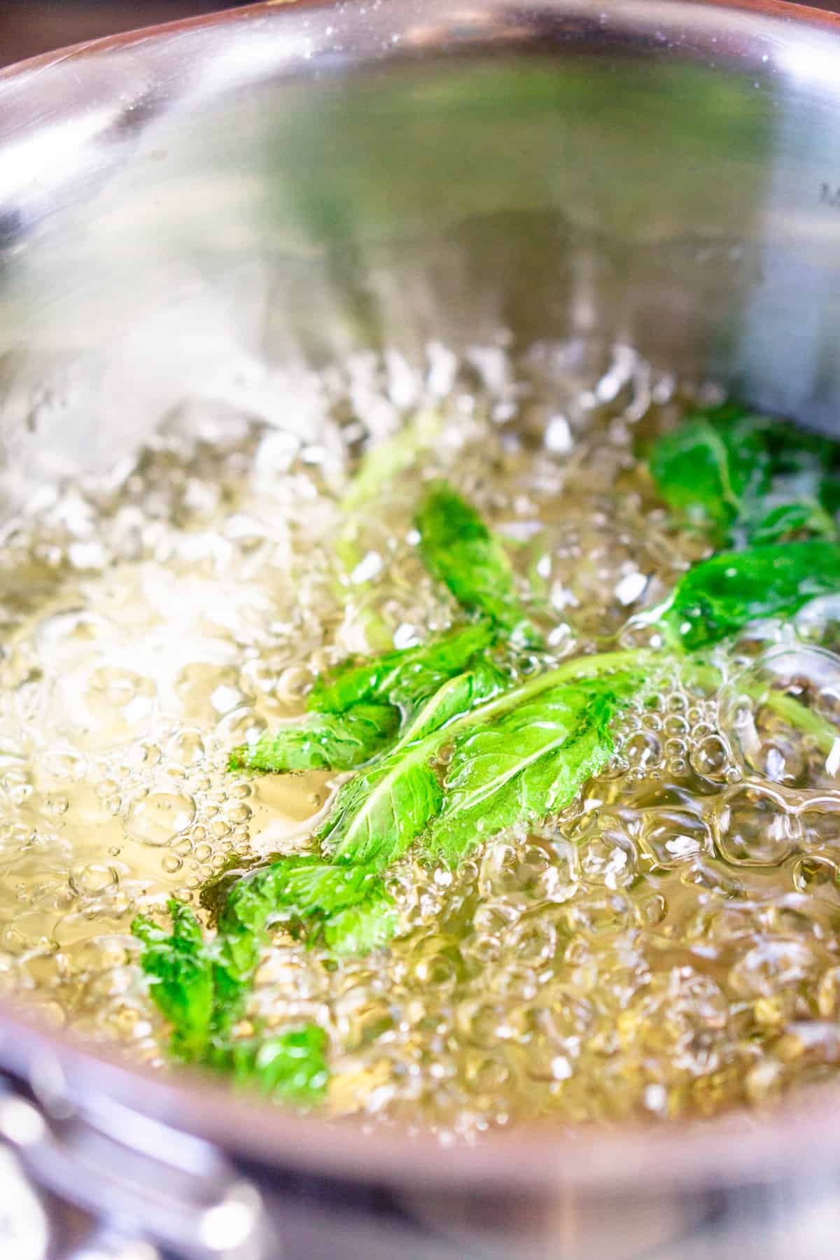 The mint simple syrup boiling to make mint-cucumber lemonade.