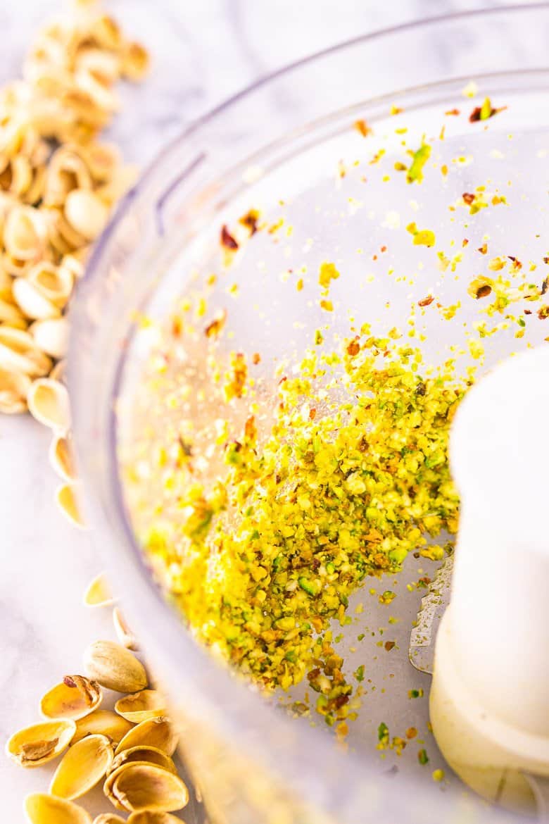 Finely chopped garlic, lemon juice and pistachios in a food processor.