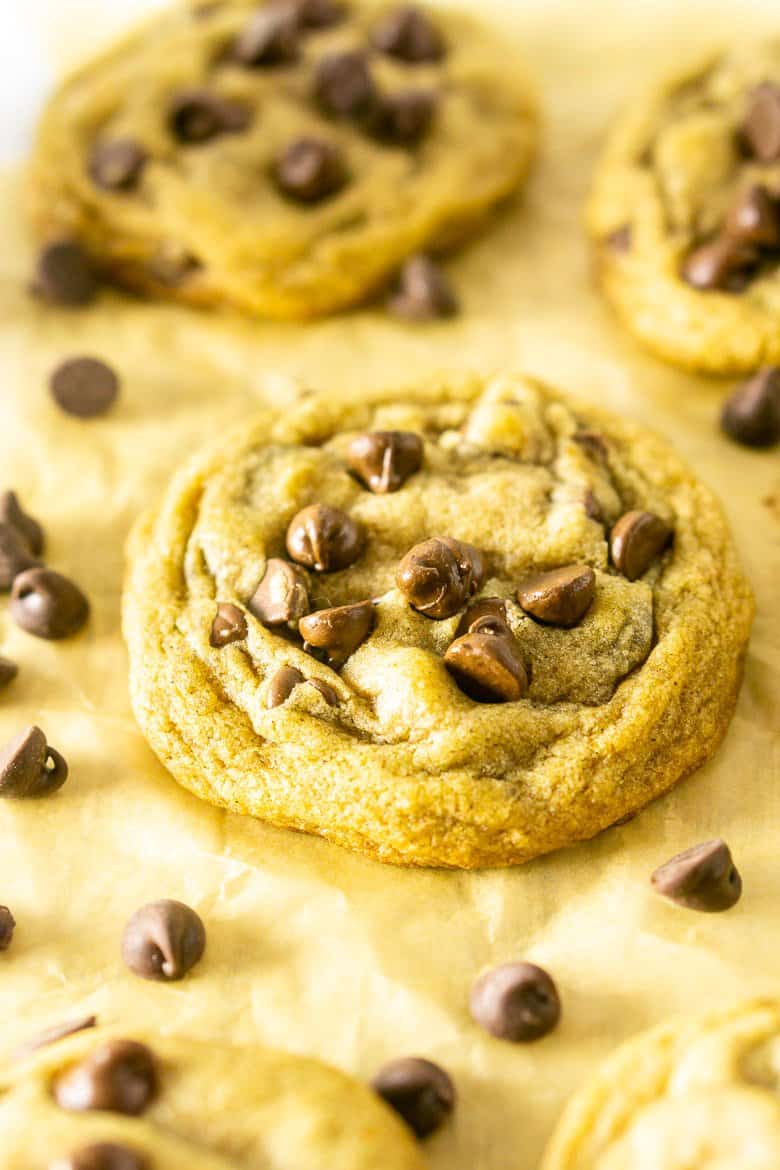 A single brown butter chocolate chip cookie with chocolate chips.