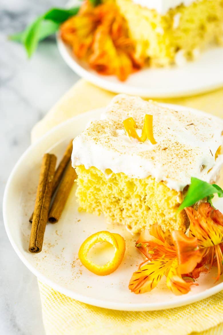 Two slices of spiced orange tres leches cake on a yellow napkin.