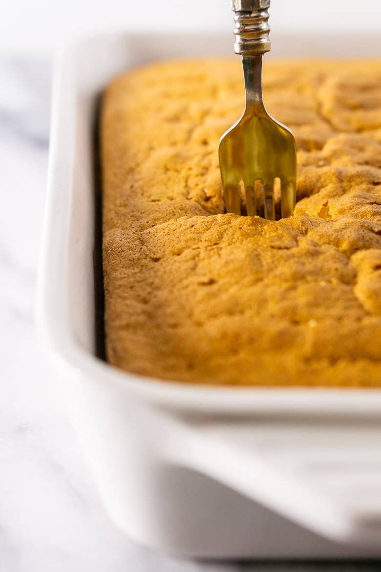 A fork poking into the spiced orange tres leches cake.