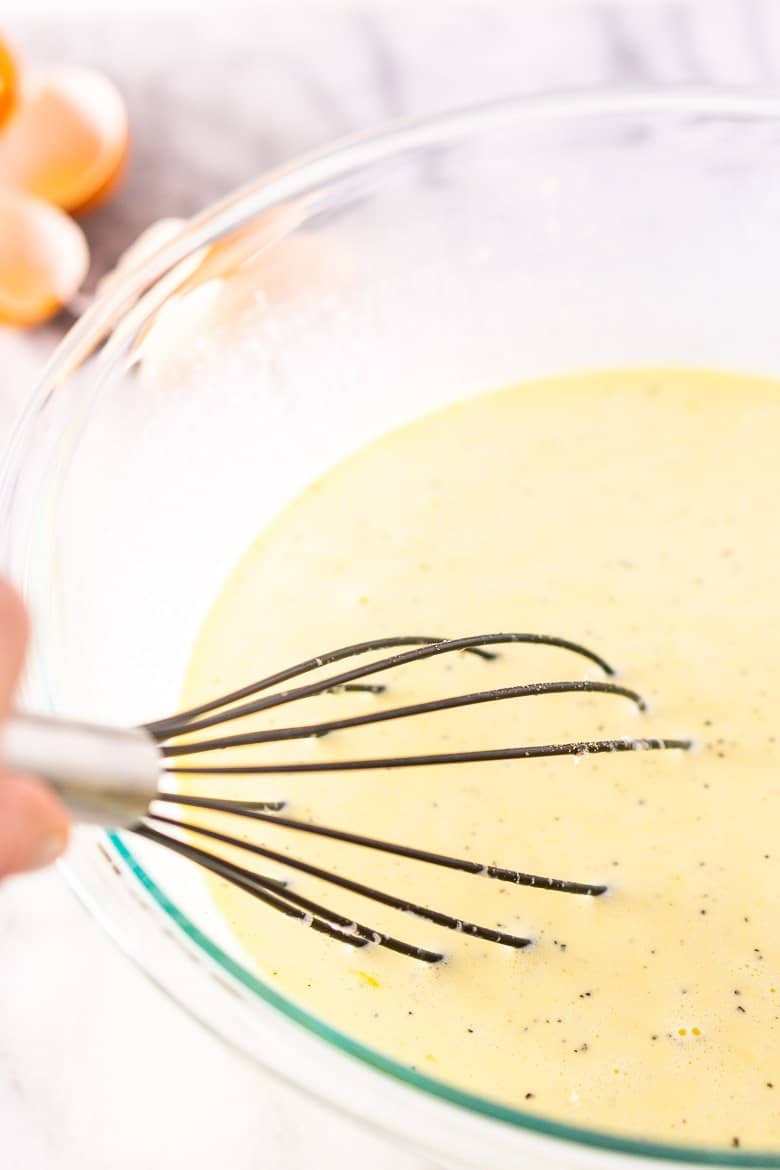 Whisking the eggs, heavy cream and milk.