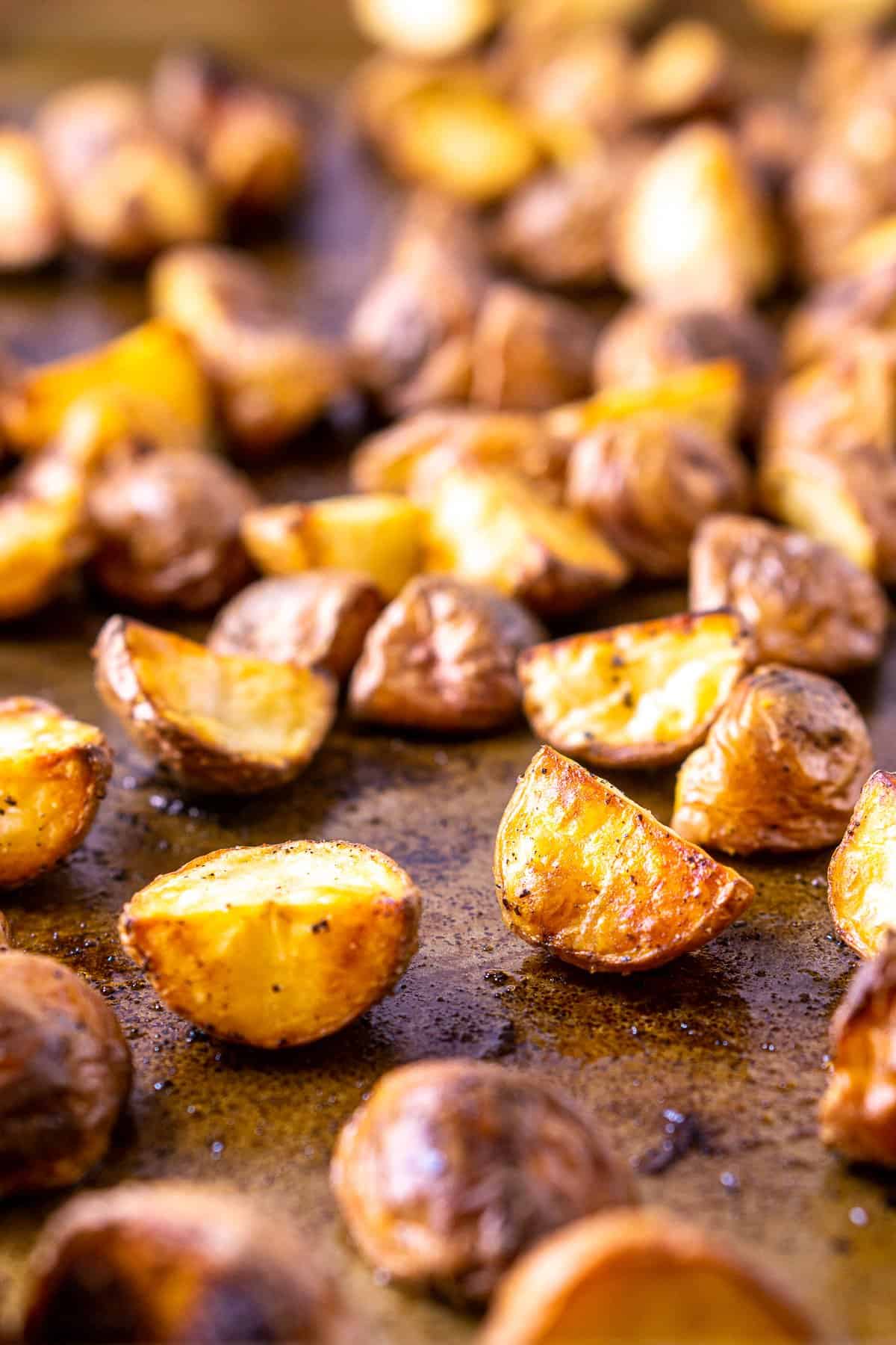 A sheet pan of the potato chunks roasted until crispy for the herbed roasted potato salad.