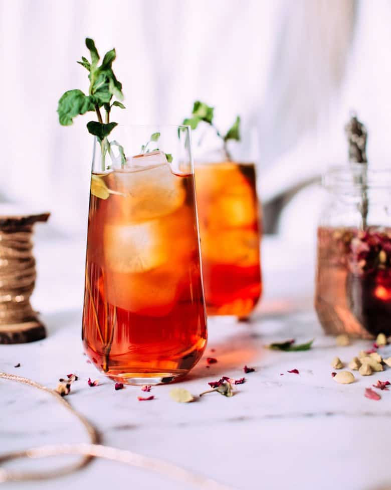 Two peach Long Island iced teas on a marble slab.