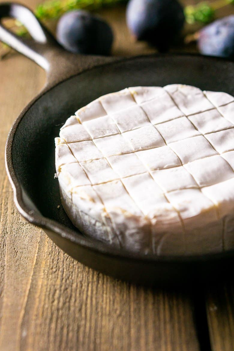 A round of Brie cut into cubes and placed in a small cast-iron skillet.