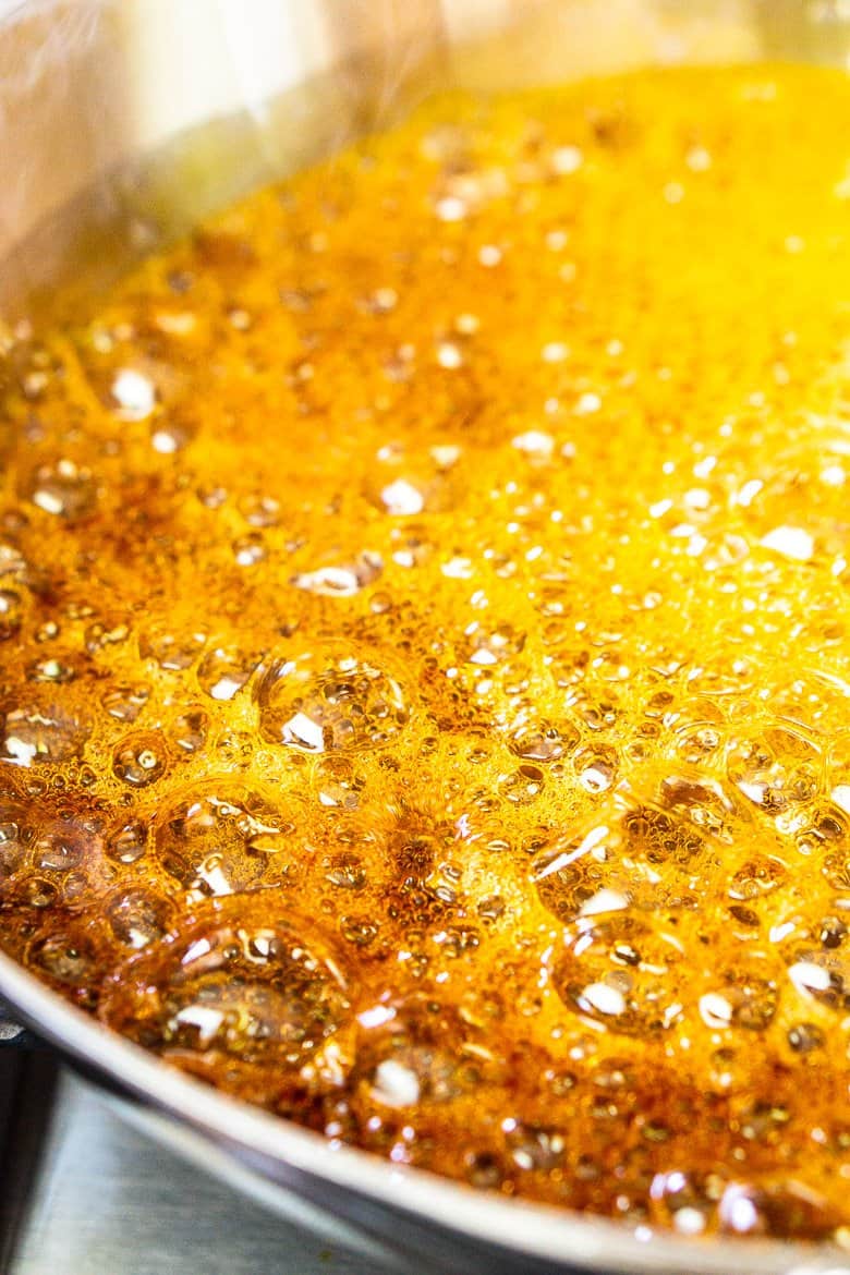 The caramel mixture turning amber and ready to be taken off the heat.