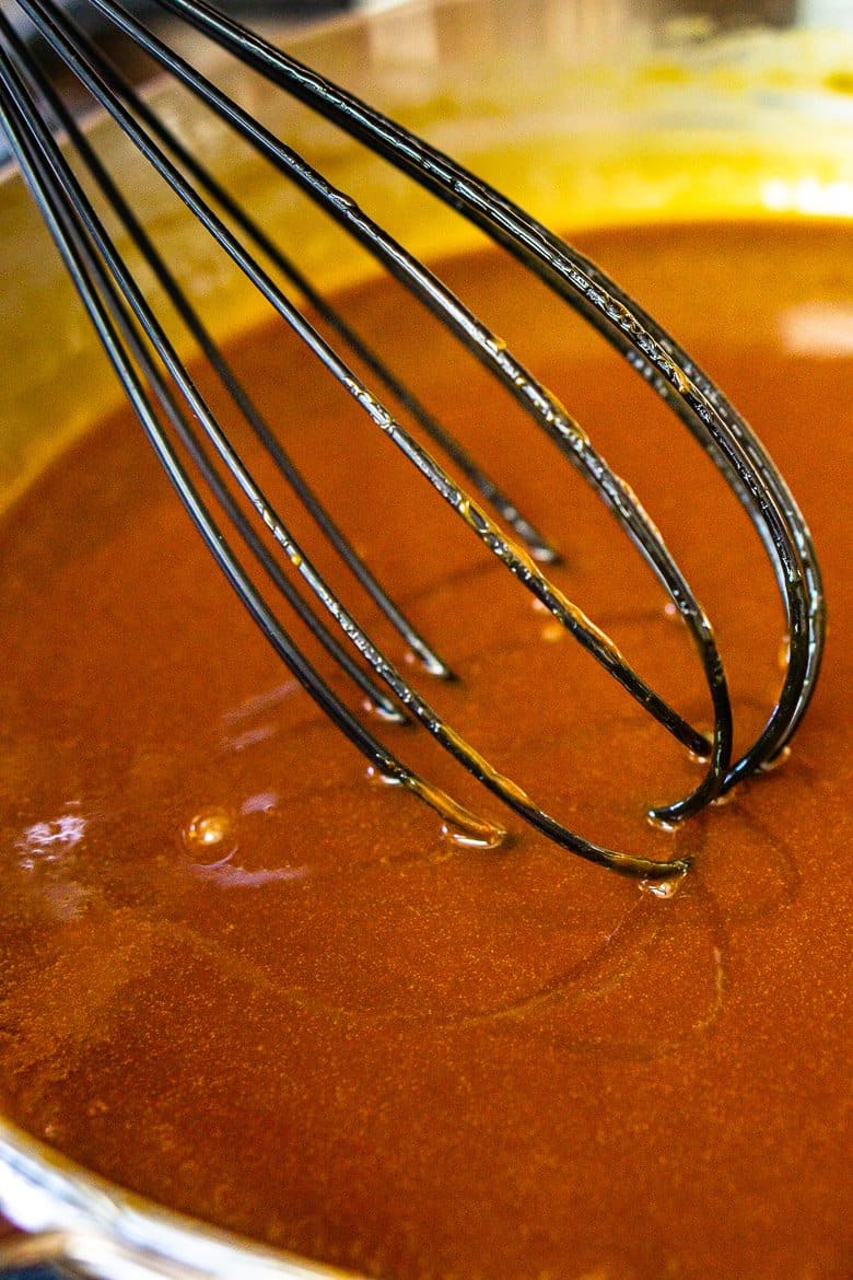 Whisking the bourbon caramel sauce until it's smooth and all ingredients are incorporated.