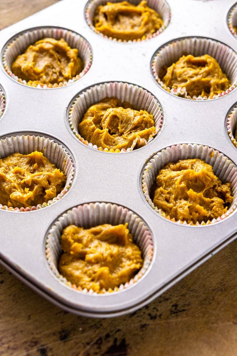 The brown butter-pumpkin cupcake batter filled in muffin tins ready for baking.