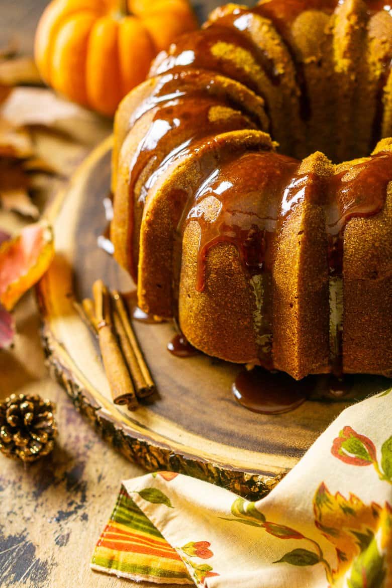 Looking down at the buttermilk-pumpkin pound cake with caramel running off it.