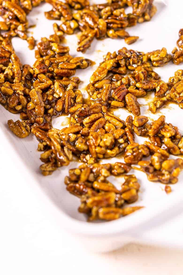 The candied pecans before cooked in a baking dish.