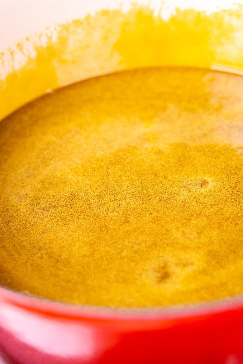 Cooking the gingerbread toffee mixture until it's smooth.