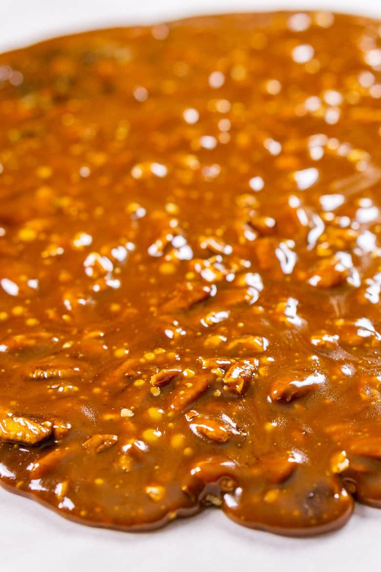 Pouring the gingerbread toffee mixture onto parchment paper.