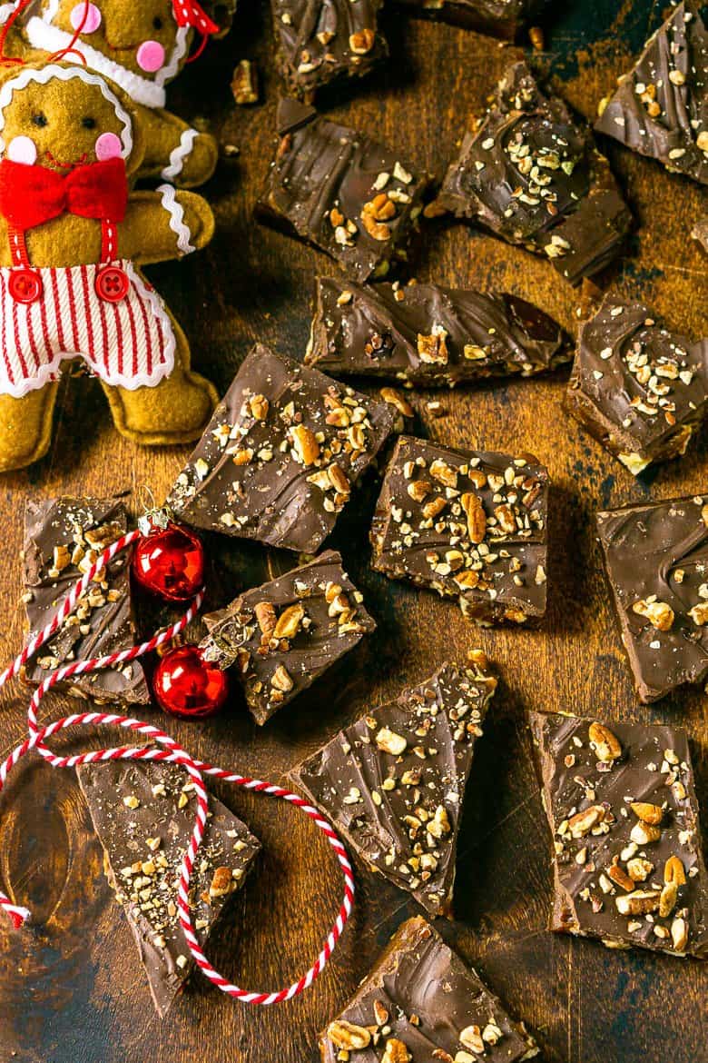 An aerial view of gingerbread toffee scattered on a wooden board.