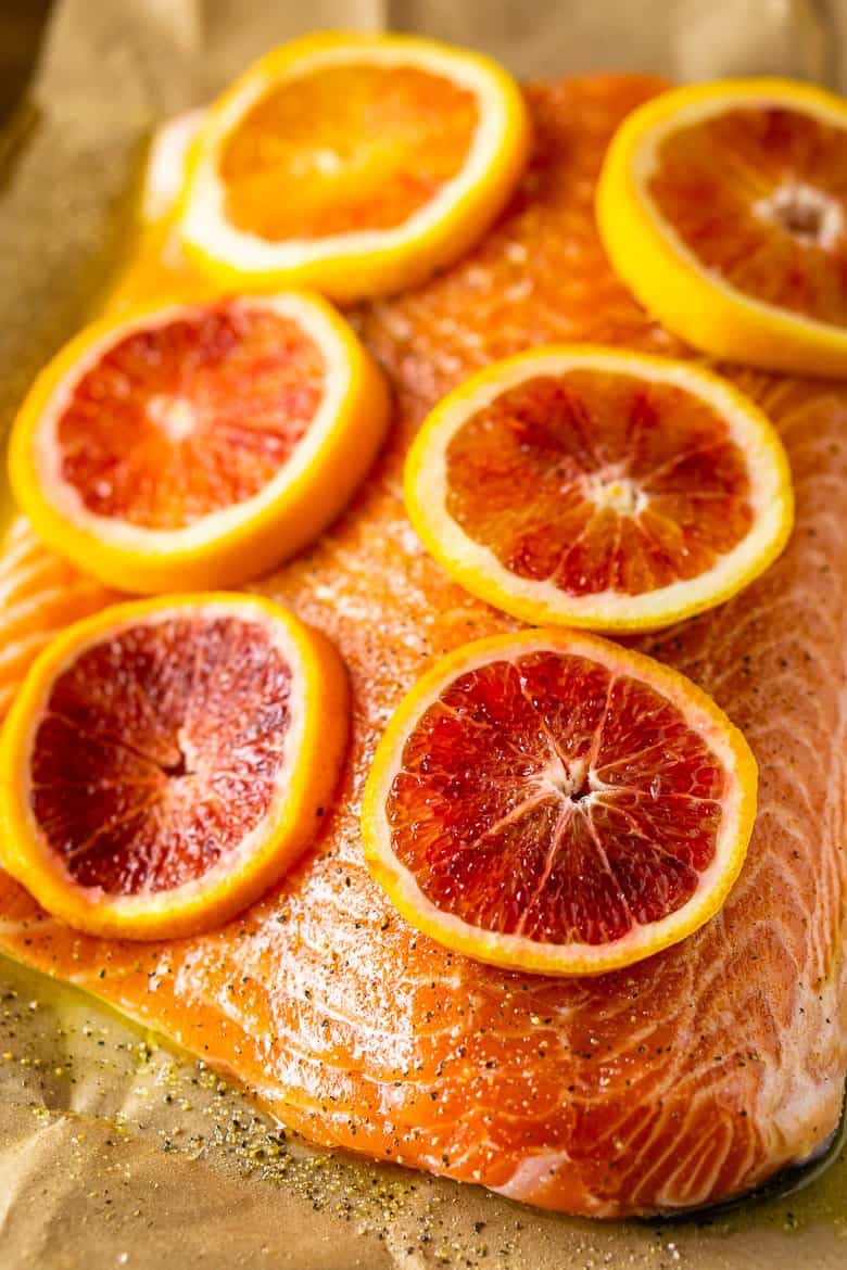 Rubbing the salmon with olive oil, salt and pepper and then placing blood orange slices on top.