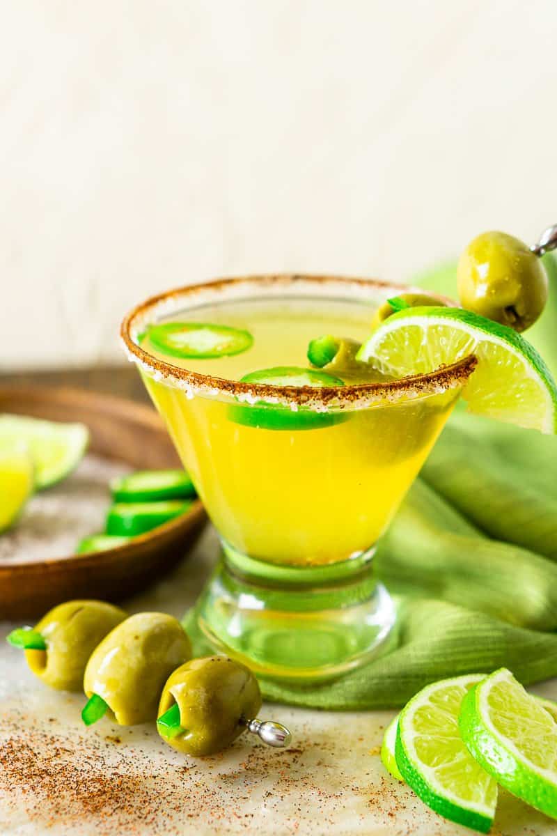 The spicy Mexican martini with a green napkin and olives.