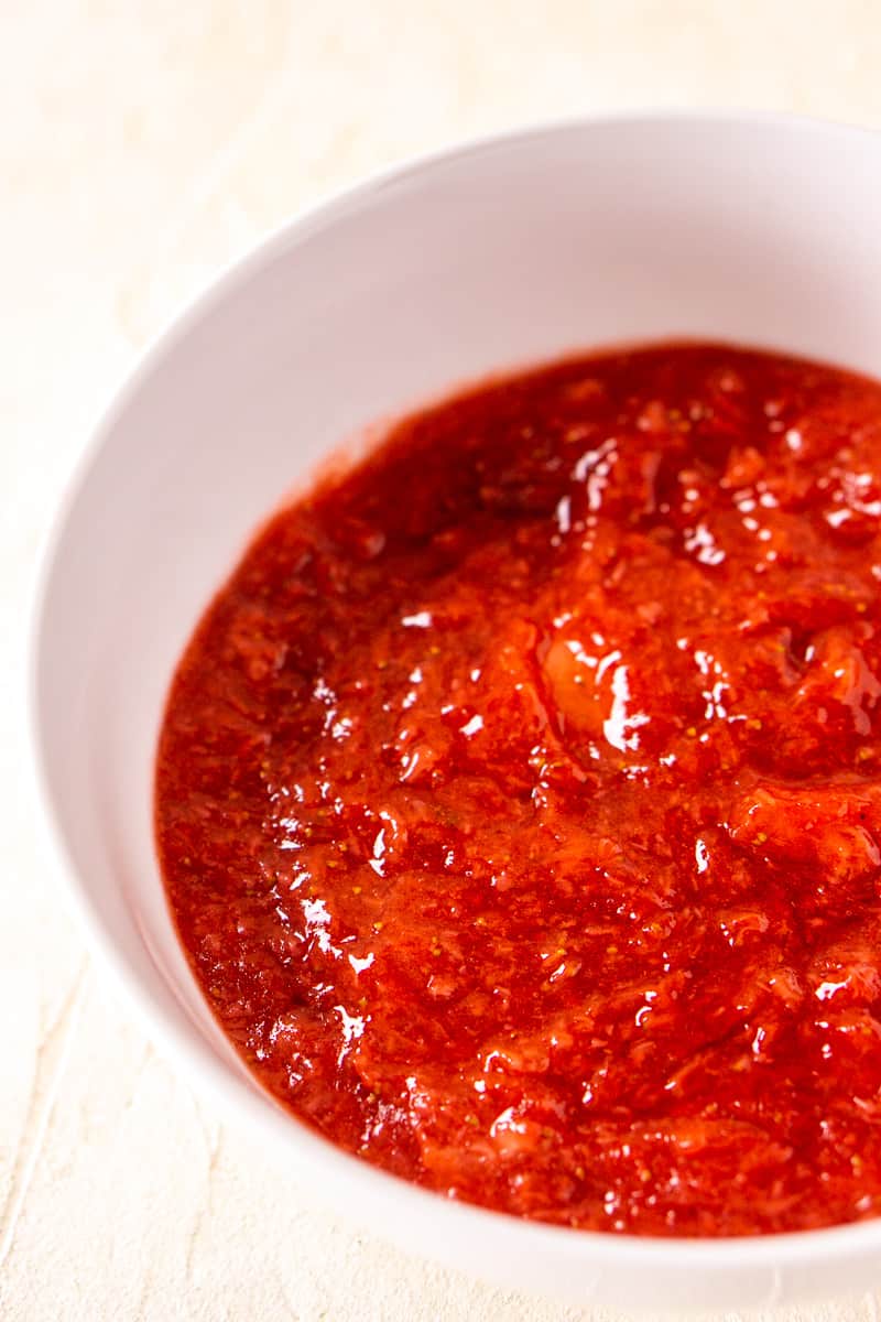 The strawberry-ginger sauce after cooking and pureeing on a white surface.
