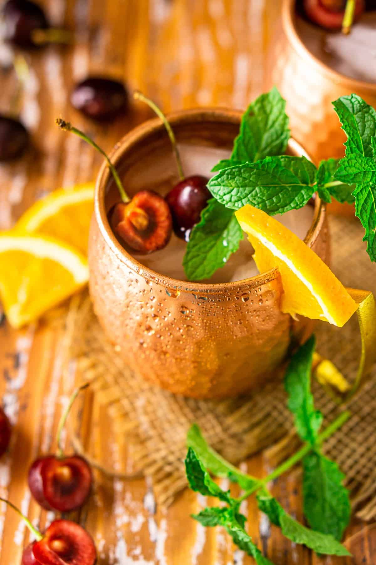 An aerial view of the Kentucky mule with cherry, orange and mint garnishes.