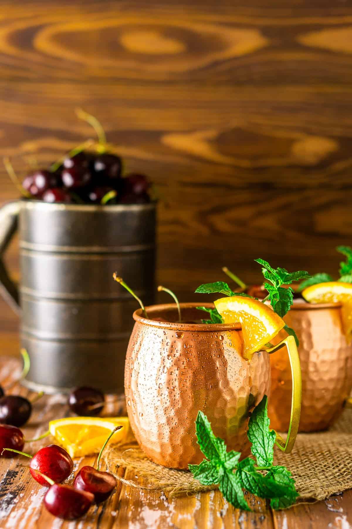 Two cherry-orange Kentucky mules with mint, cherries and orange slices.