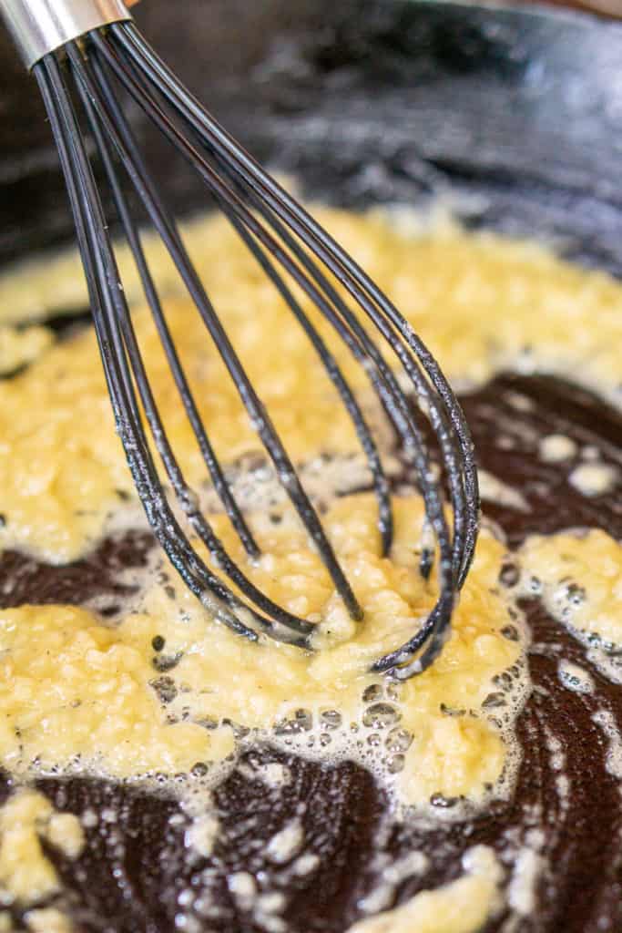 Whisking the butter and flour together in a cast-iron skillet to make the gravy roux.