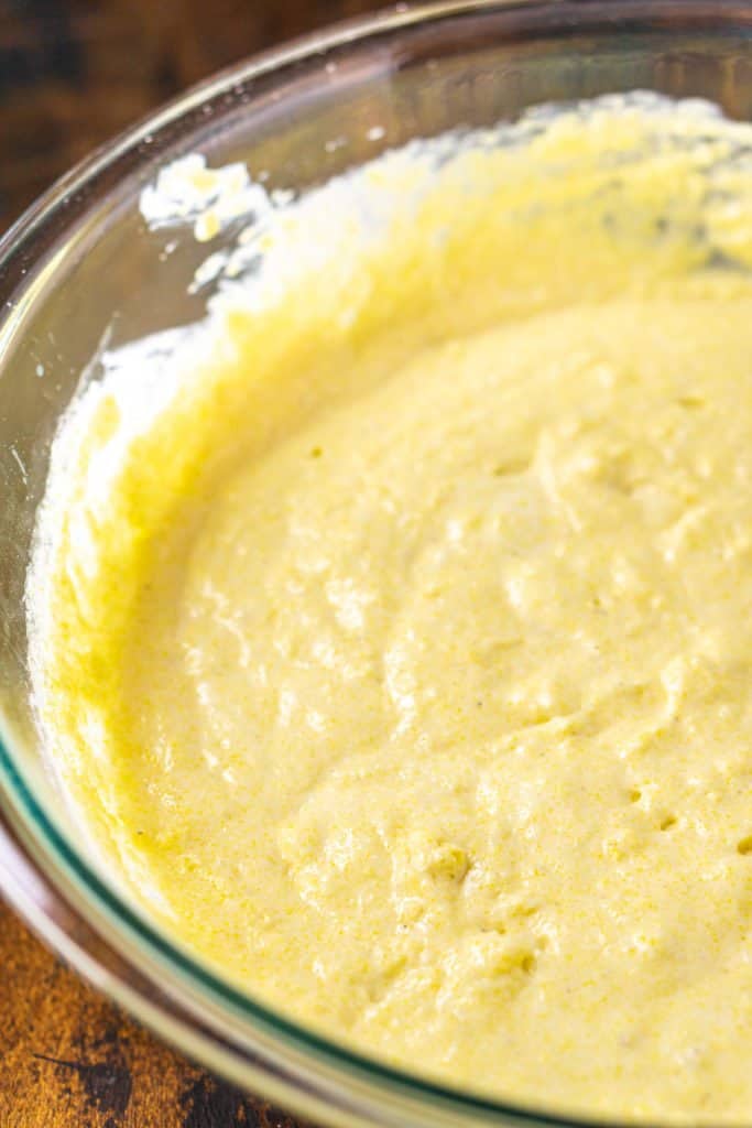 The cornbread batter after the dry ingredients have been added, showing that the mixture is a bit lumpy.