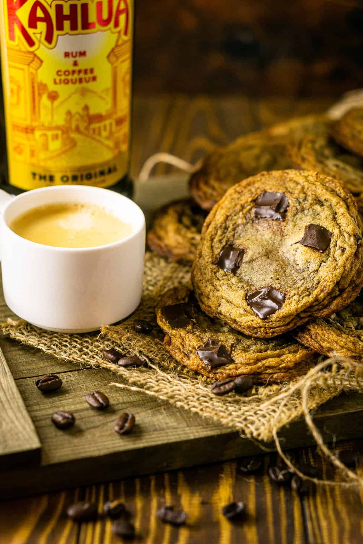 The espresso and Kahlua cookies on wooden tray with coffee beans around it.