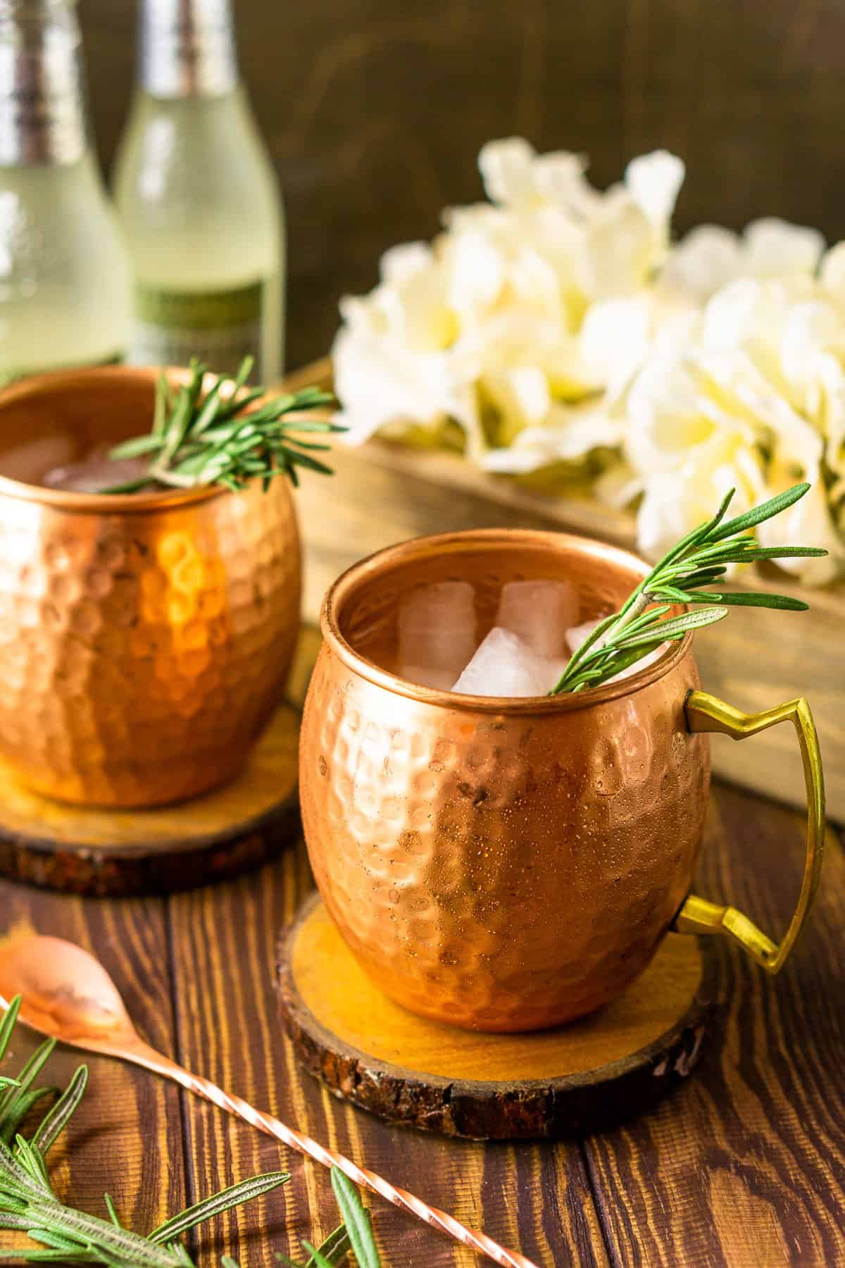 A side view of the bourbon mule with white flowers behind it.