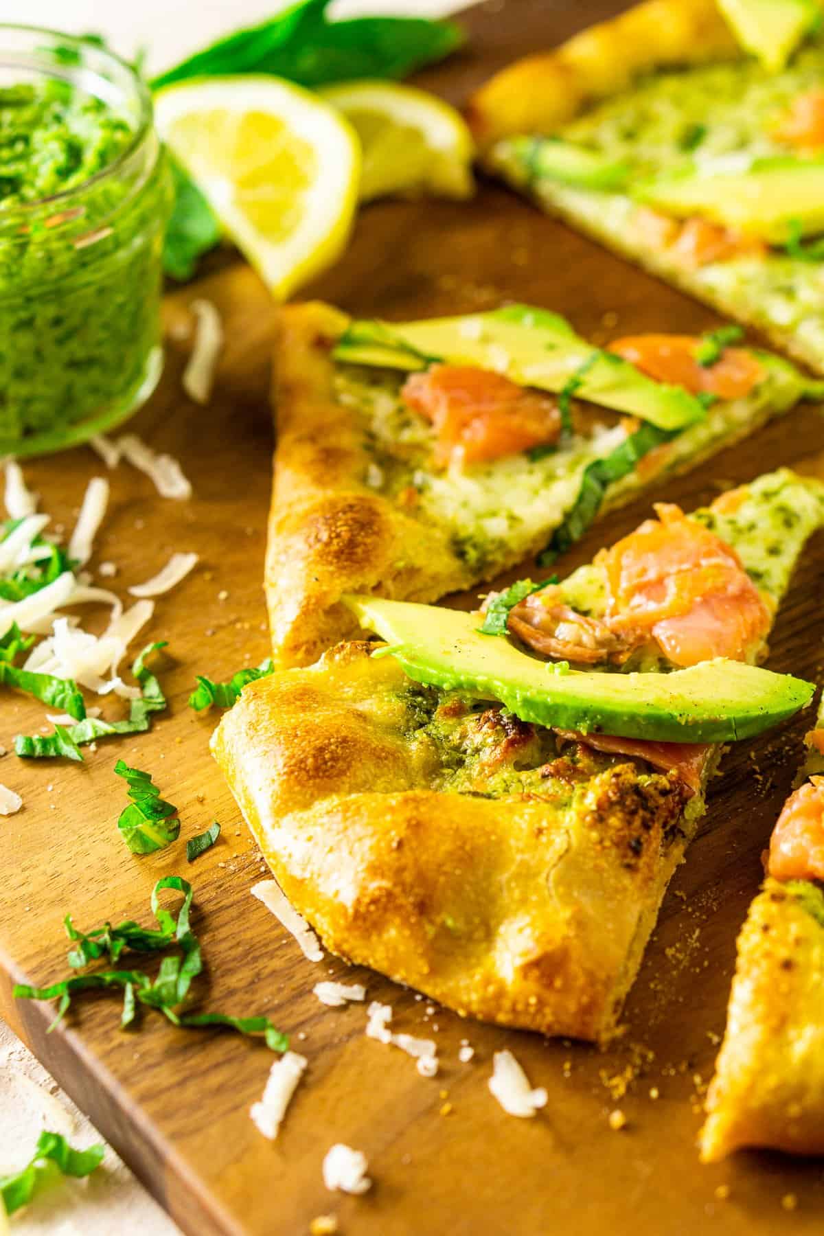 The smoked salmon and avocado pizza with pesto after it's been sliced.