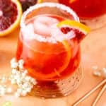 A blood orange margarita with cut-up blood oranges.