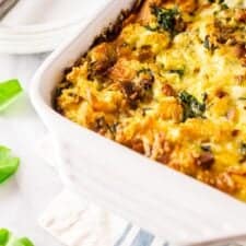 A pan of cooked bacon, Gruyere and spinach strata on a napkin.