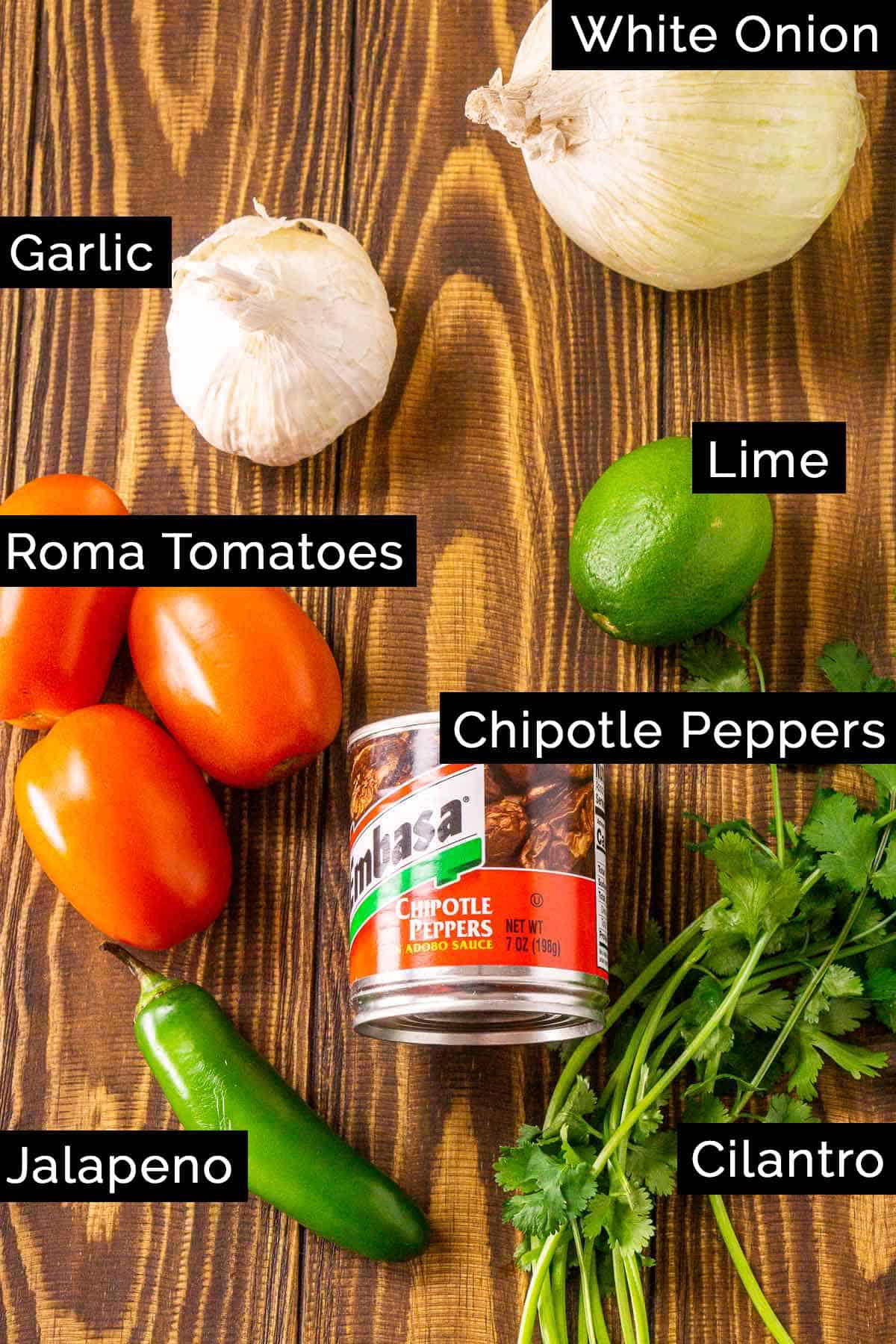 The ingredients on a wooden board with black and white labels.