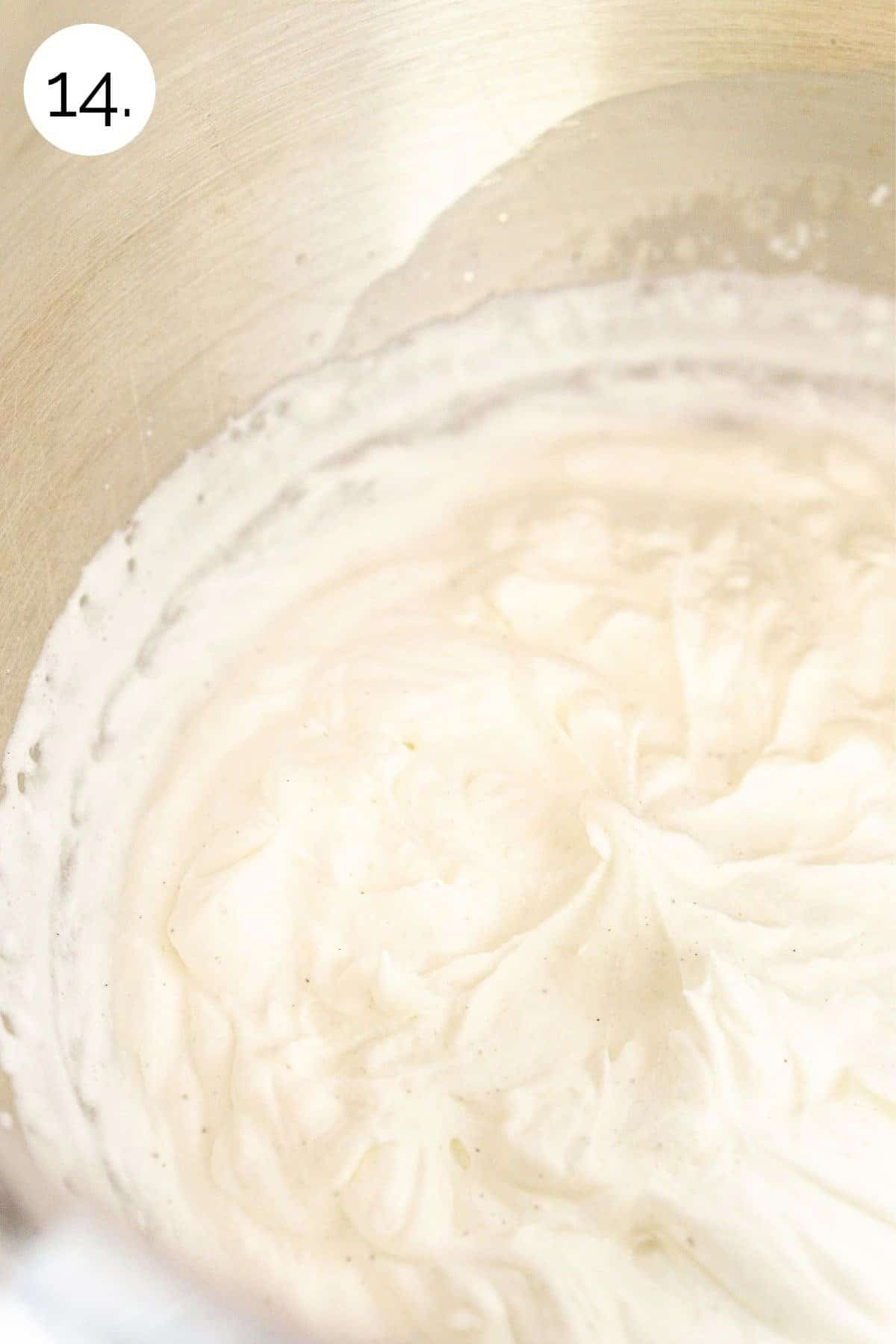 Beating the whipped cream in a mixing bowl until stiff peaks form.