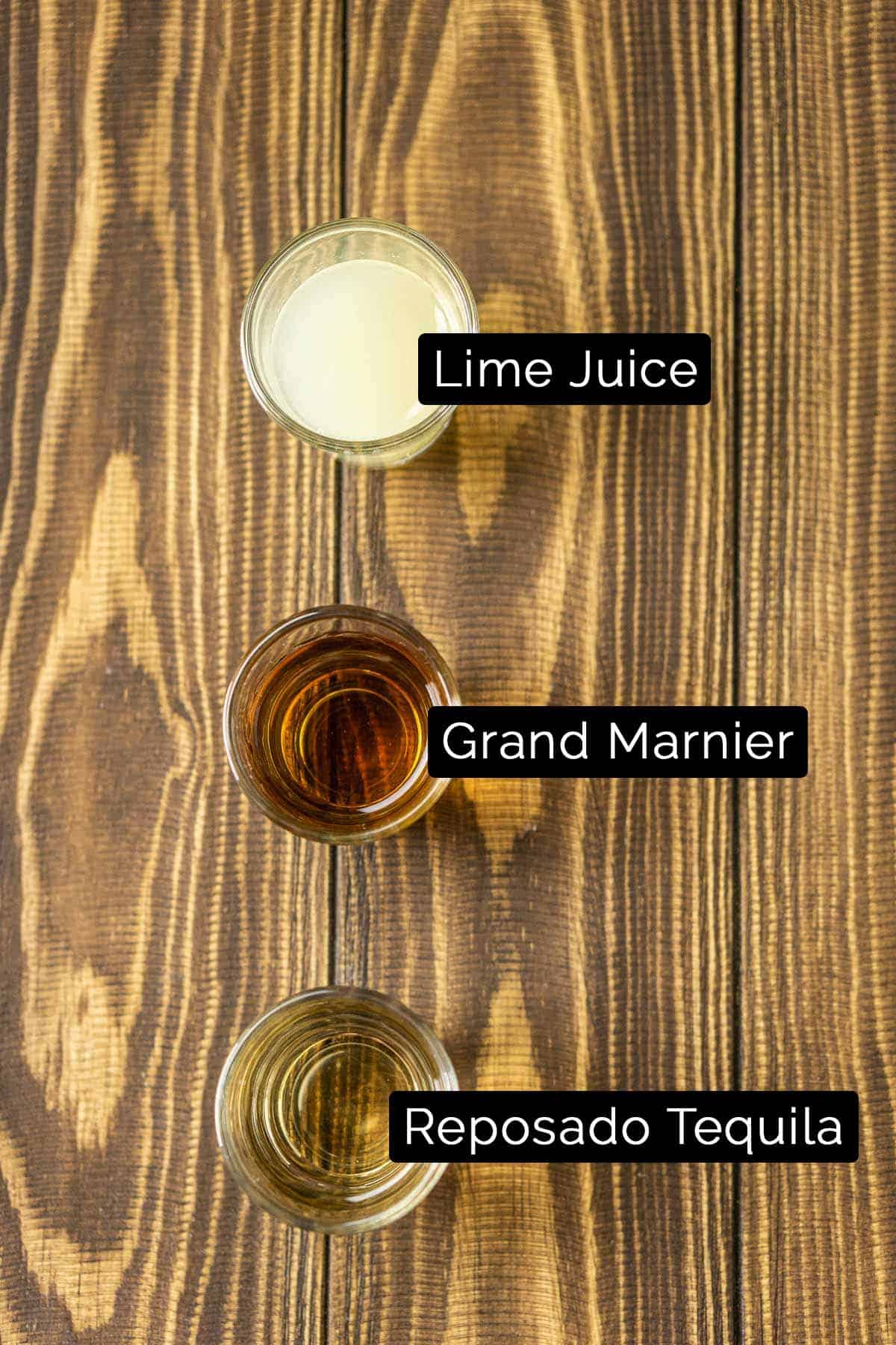 The ingredients on a wooden board with black and white labels.