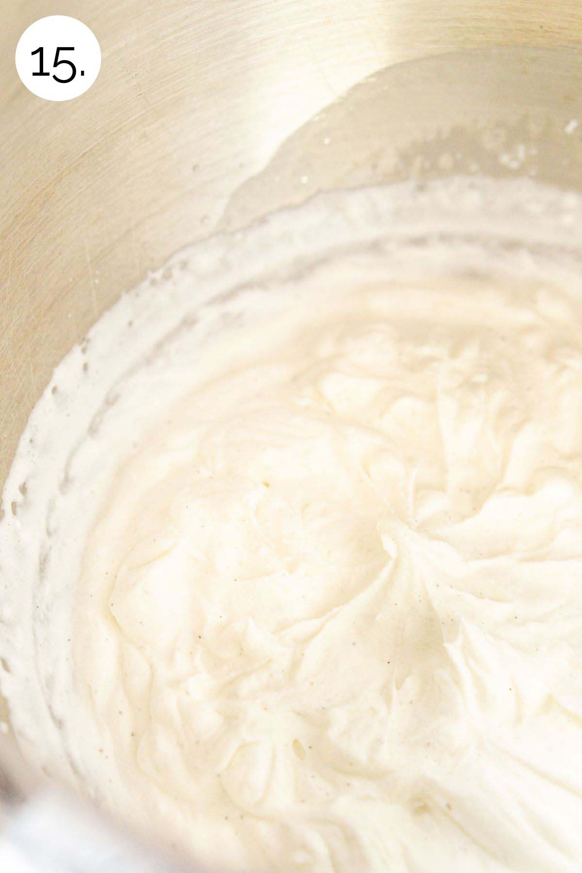 Beating the maple whipped cream in a bowl until stiff peaks form.