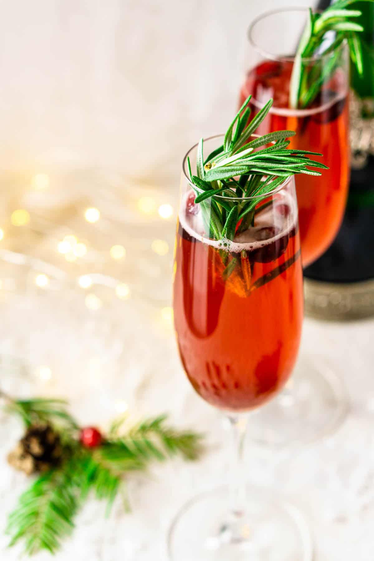 A Christmas mimosa with pine and holly decor to the side.