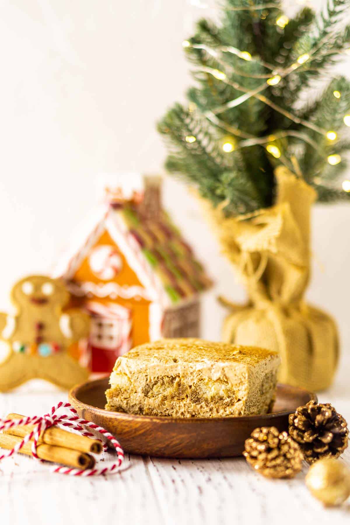 Looking straight on to the gingerbread tiramisu with a small Christmas tree and decor around it.